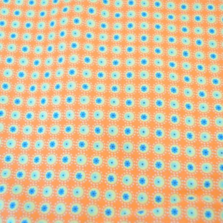 Tissu coton à fond orange surmonté de petits ronds jaunes et bleus